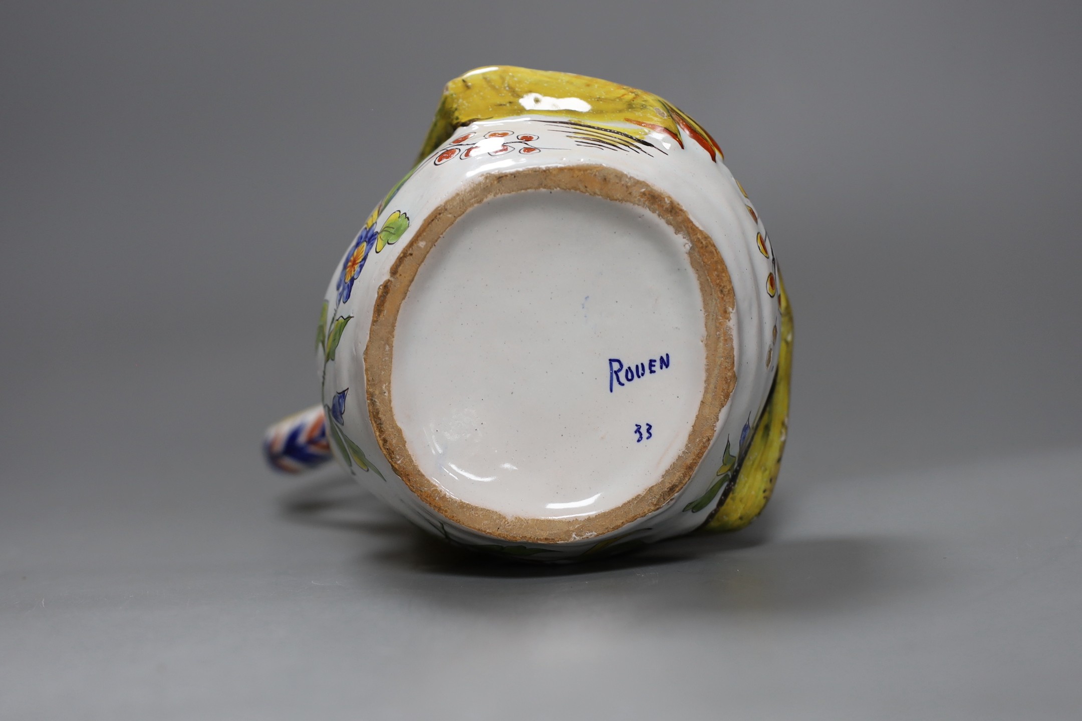 A Rouen faience grotesque jug, 19.5 high
